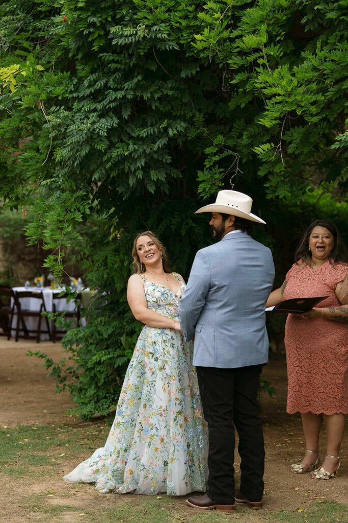 Candid photo of bride laughing and looking at guests during wedding ceremony