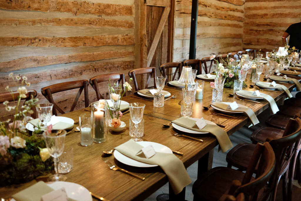 Detail photo of a wedding dinner table with whimsical florals and candles