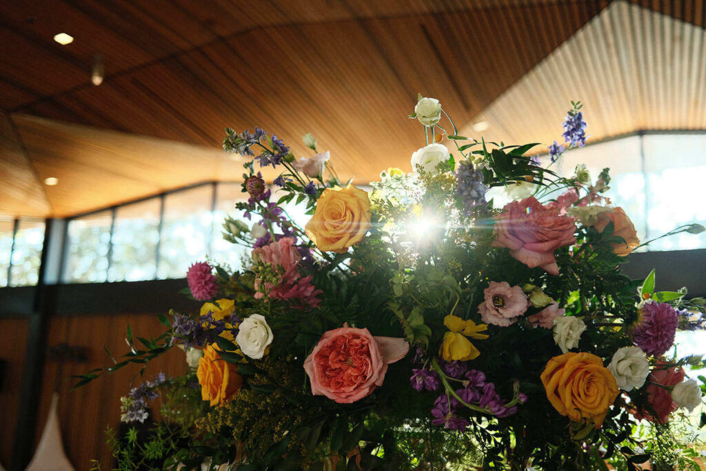 Sunlight shining through a floral arrangement inside The Betty Kelso Center