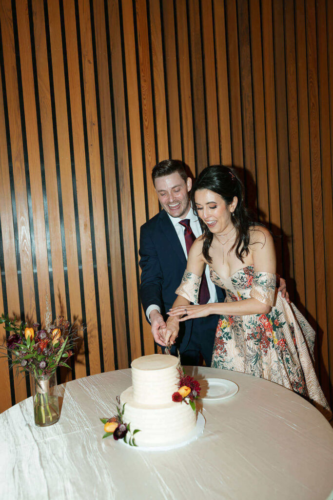 A bride and groom cutting their wedding cake at Betty Kelso Center