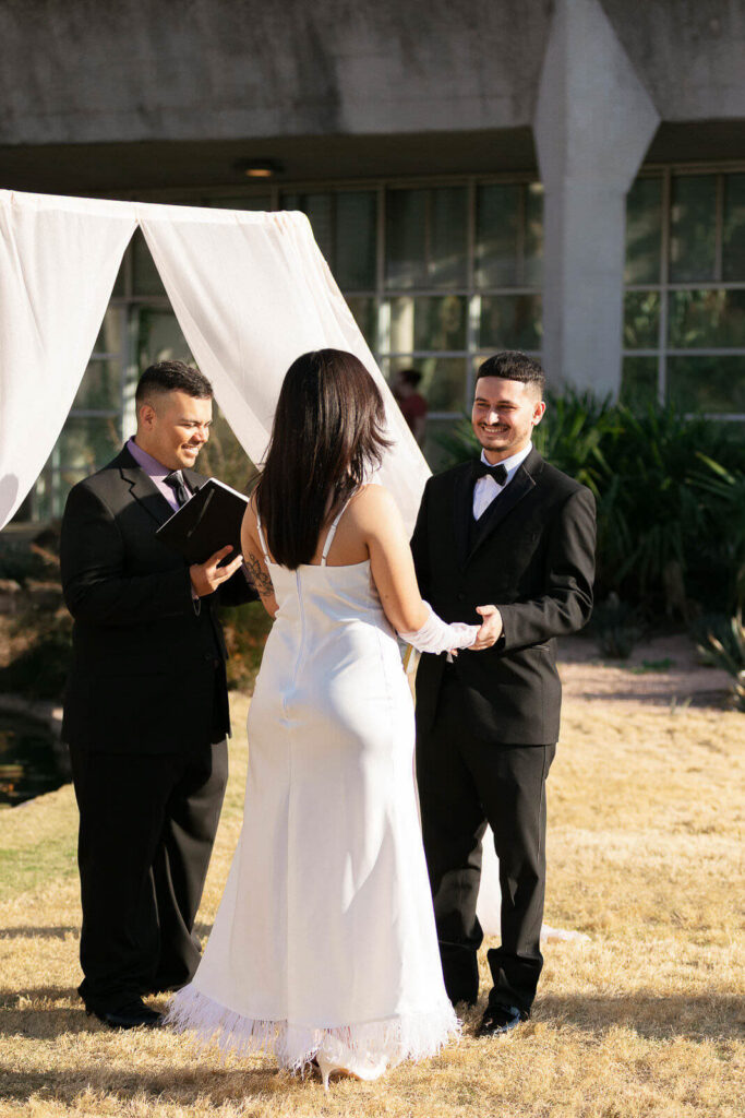 Groom smiling in the sun at Lucile Halsell Conservatory wedding ceremony
