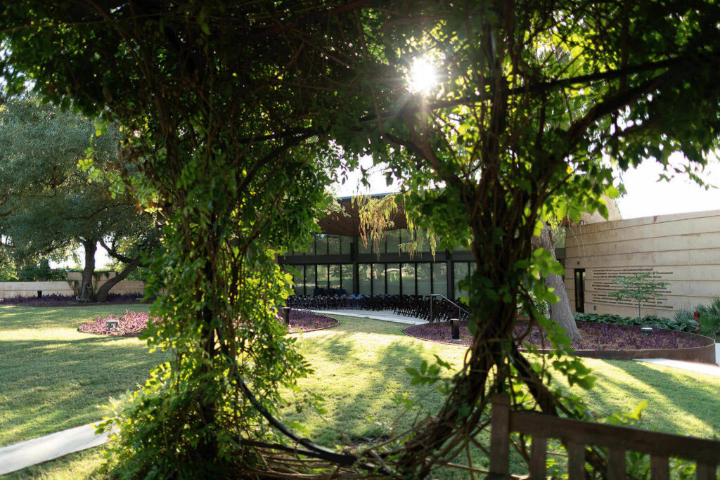 View of the patio of The Betty kelso Center from Wisteria Arbor at The San Antonio Botanical Garden