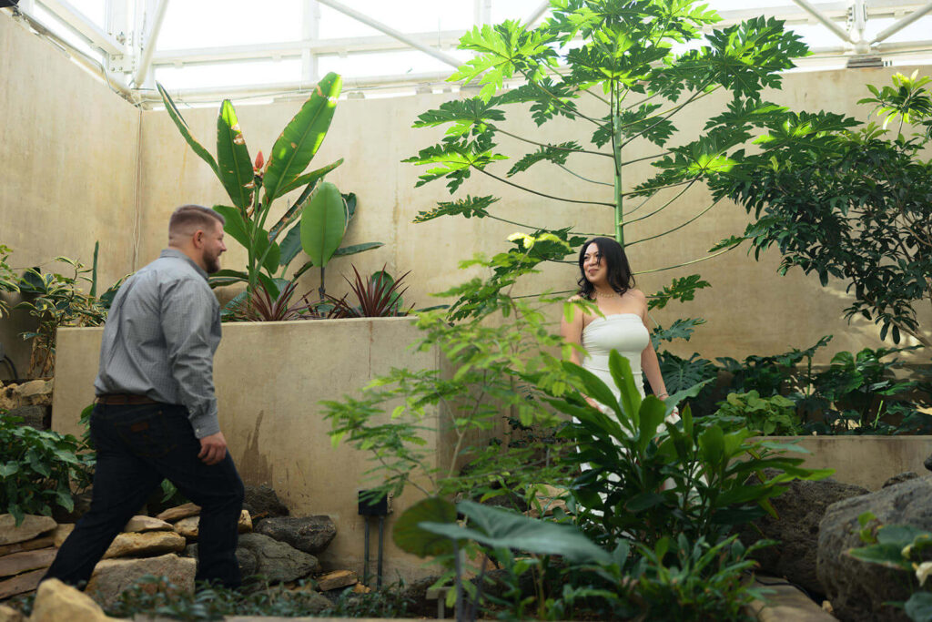 Couple playing tag inside Gretchen Northup Tropical Conservatory